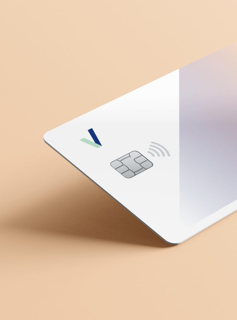 White contactless Pervesk Visa debit card in a pink background.